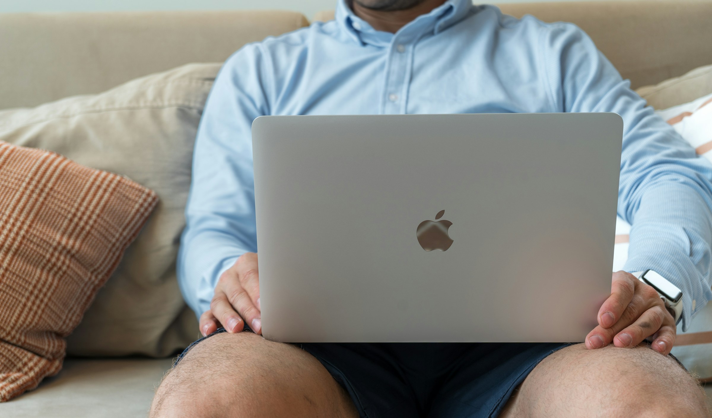 man with laptop in lap - Jasper AI Alternatives