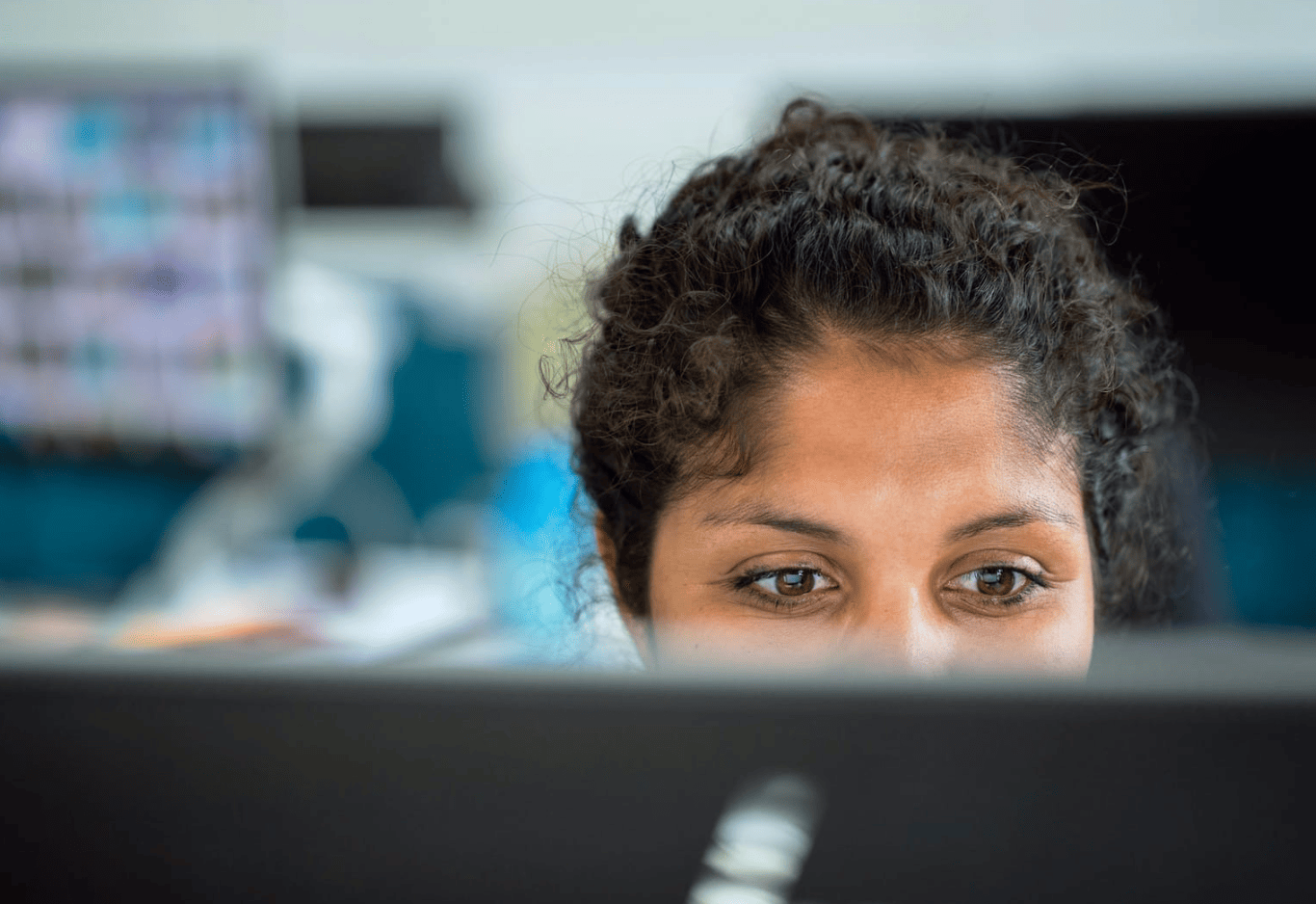 woman sitting in front of computer - How to Repurpose Blog Content for Social Media