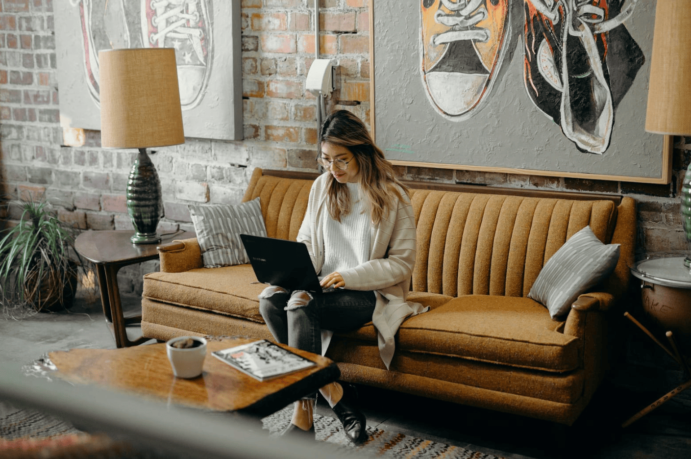 woman with laptop on lap - SEO Content Writing Software