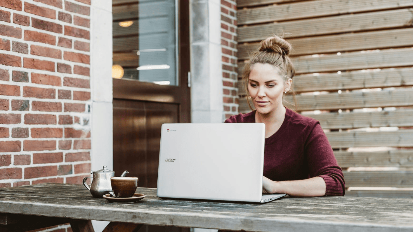 woman sitting infront of laptop - SEO Content Writing Software