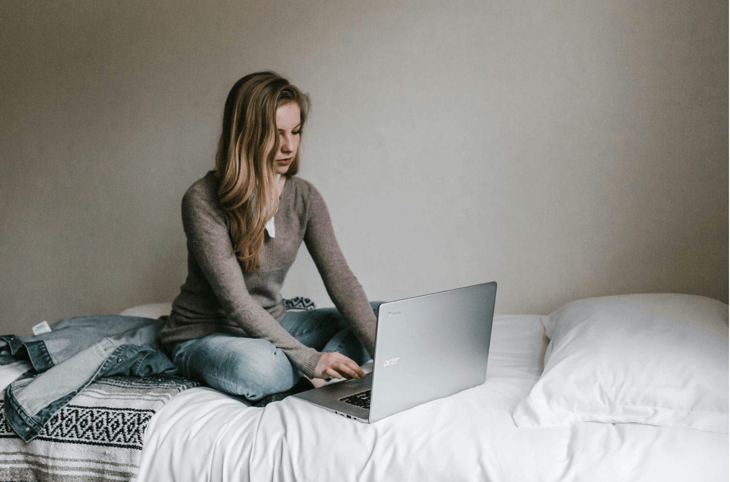 person sitting on bed - Benefits Of Using AI Writing Tools