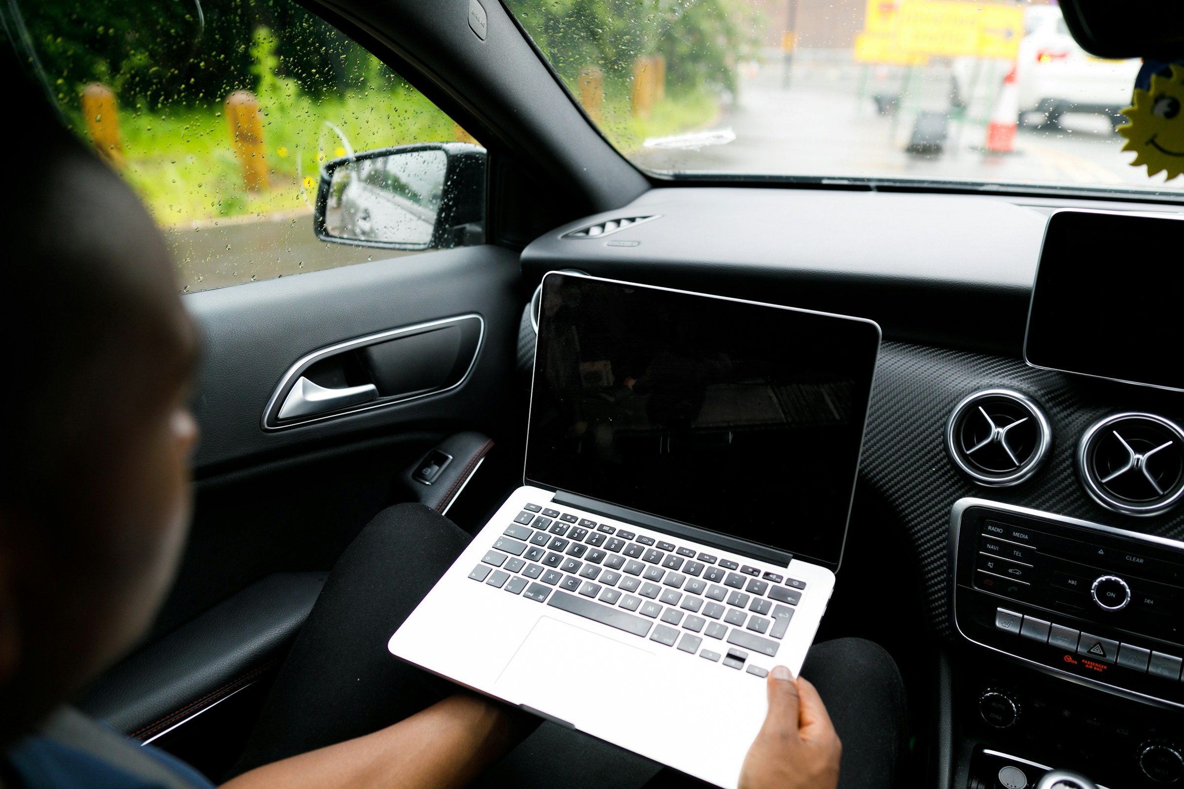 Person Using Laptop in Car - Byword AI