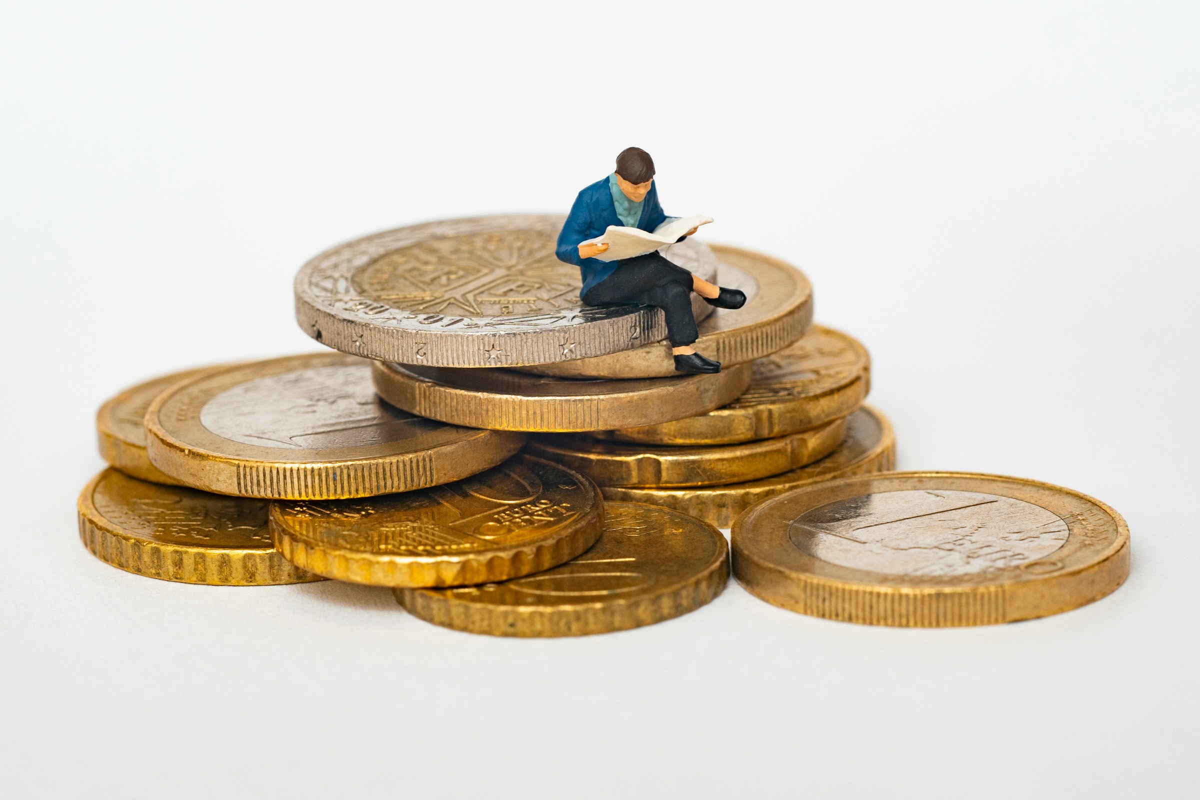 person sitting on coins - Seowriting.AI