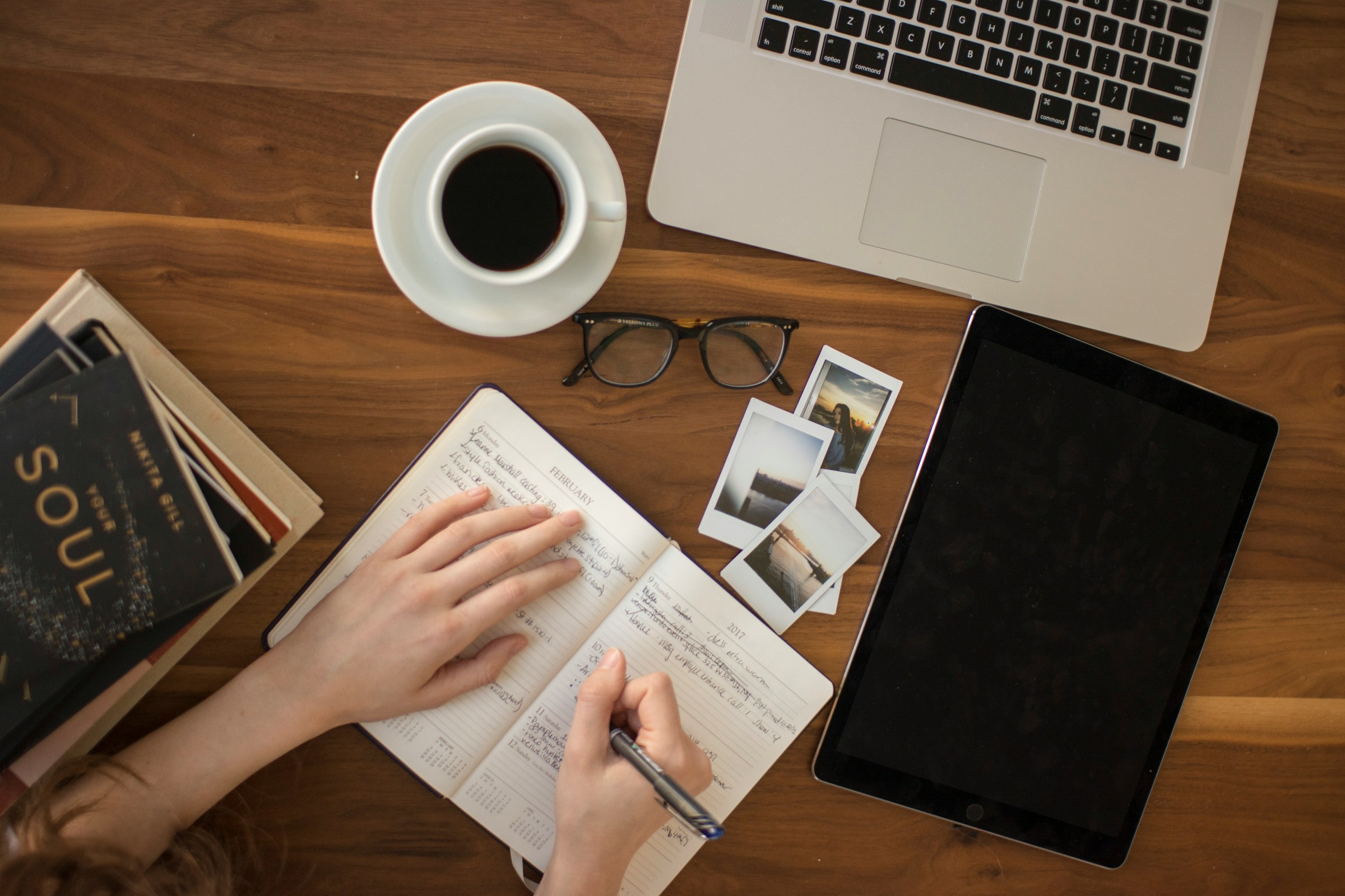 Person Writing on Notebook - Quillbot Alternative